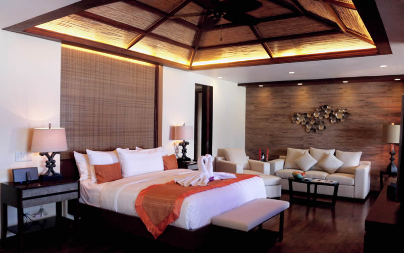The beachfront casa: king bed, bamboo ceiling, lounge seating.