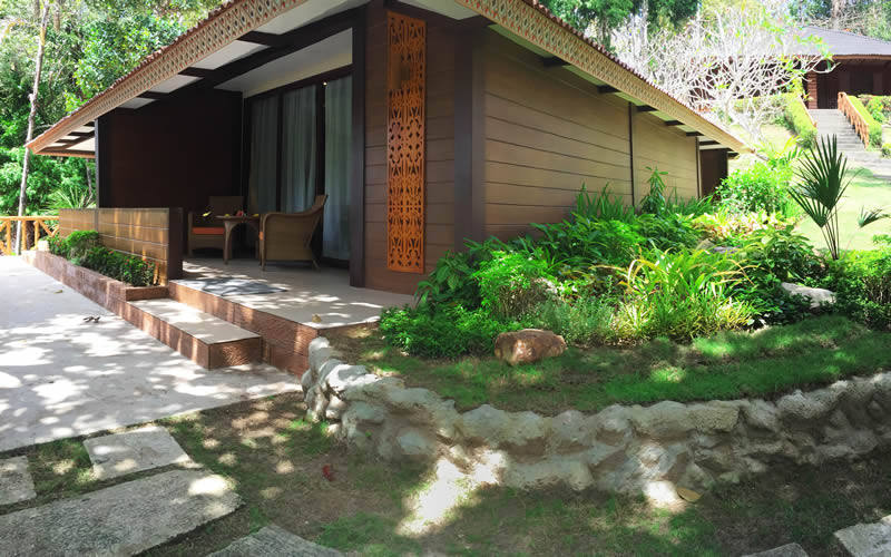 A garden casita among palms and planting.